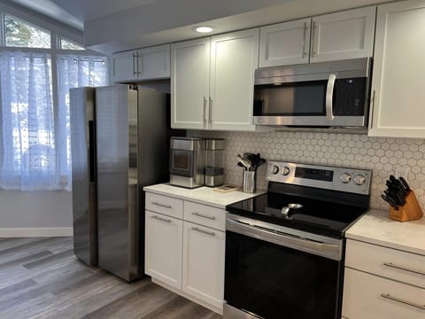 Side by side refrigerator, glass top 5-burner stove, oven, microwave, dishwasher