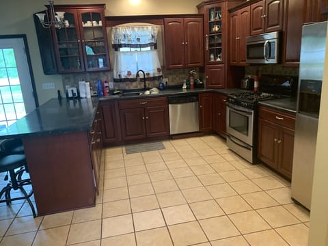 Cherry cabinets and stainless appliances.
