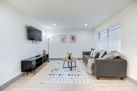 Spacious living room space with a sofa and smart TV