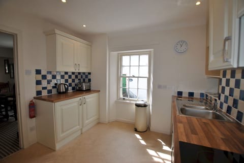 The kitchen is located next to the open-plan dining area and lounge