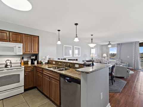 Your spacious kitchen features granite countertops, modern appliances, and an open layout perfect for cooking and entertaining.