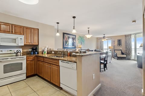 Your fully-equipped kitchen opens to a spacious living area, perfect for preparing meals and gathering with loved ones in comfort.