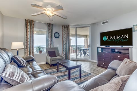 Unwind in your spacious living room with plush leather seating, modern entertainment center, and sliding doors to your private balcony.