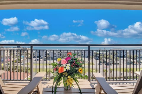 Bright flowers frame spectacular ocean views from your private balcony, creating the perfect spot for morning coffee.