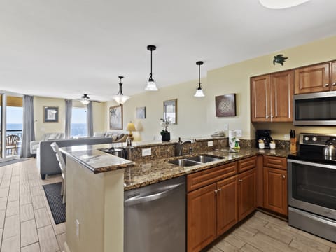 Your fully equipped kitchen opens to stunning ocean views, perfect for preparing meals while enjoying the seaside breeze.