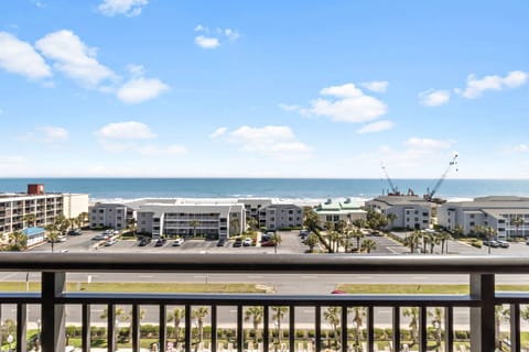 Wake to stunning ocean views from your private balcony, where palm trees frame the sparkling coastline beyond.