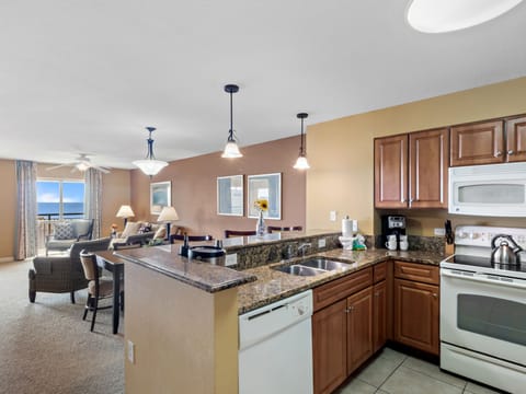 Your open-concept kitchen flows beautifully into the living area, where ocean views create the perfect backdrop for memorable vacation meals.