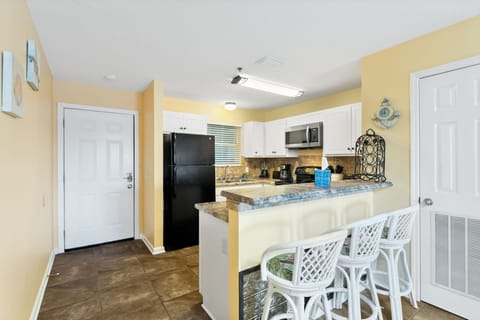 Kitchen area with breakfast bar.