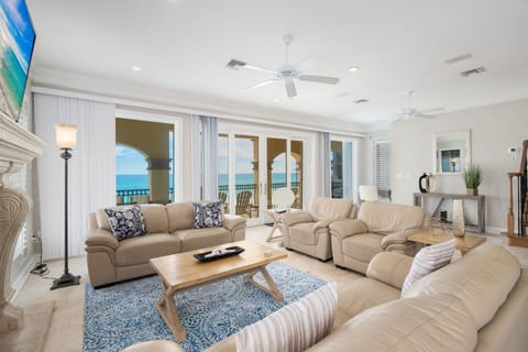 Sink into plush leather sofas as ocean breezes flow through your expansive living space, where floor-to-ceiling windows frame stunning sea views.