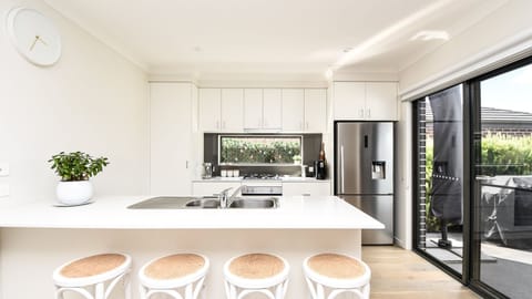 Our property's light-filled kitchen is a true gem, offering a perfect blend of style and functionality, making it a joy to prepare meals or simply unwind.
