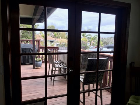 French doors off the kitchen lead to bbq grilling deck and outdoor dining table.