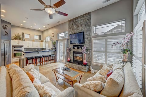 Family room with gas fireplace and large TV.