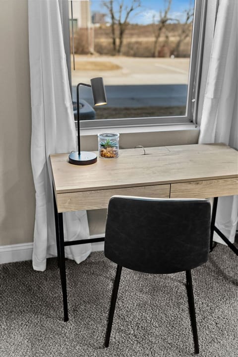 Dedicated workspace with a clean desk, comfortable chair, and natural light—ideal for remote work, planning your day, or catching up on emails in a quiet setting.