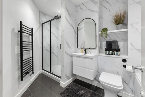 Luxury bathroom with a large shower and bath .