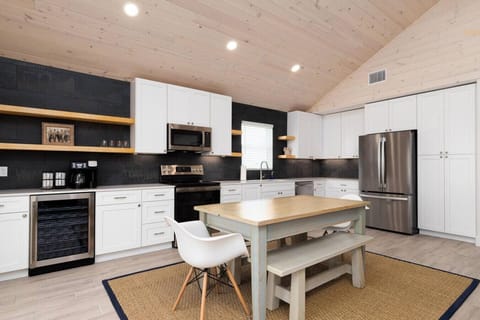 Fully stocked kitchen with modern appliances and a roomy dining setup—ready for family feasts.