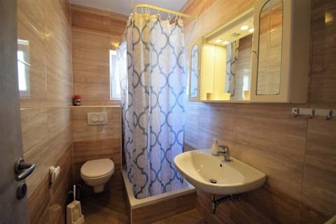 Clean bathroom with shower and sink.
