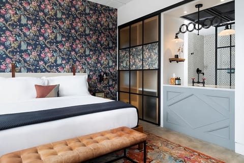 Lounge on plush linens with chic industrial-glass accents.