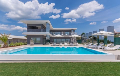 A view of the luxury villa Nimai Luce with a swimming pool in the town of Kaštelir in Istria