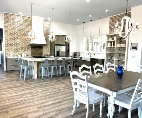 Dining for 18 in one area. Custom built dish shelf unit, range hood, 10' island