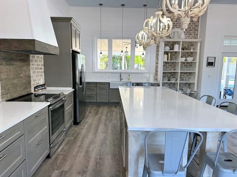 Loads of counter space, farmhouse sink, microwave in island, window to patio