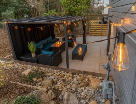 Spend a beautiful night in the backyard under this cozy pergola with a fire pit!