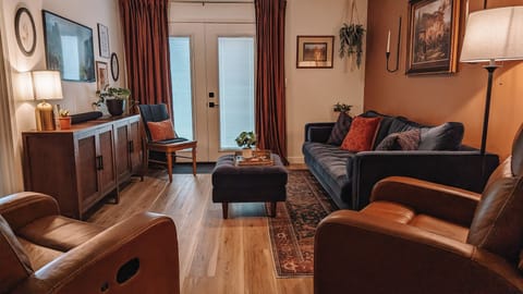 The living room includes 2 reclining leather chairs along with full size sofa.