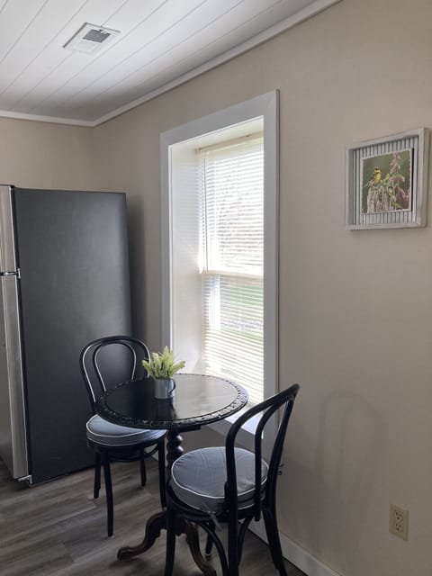 Kitchen with stainless refrigerator and table seating for two