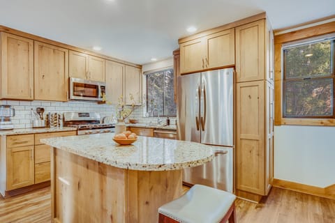Kitchen features an island and modern appliances.