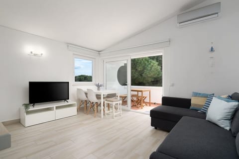 A comfy living room with a sofa bed for 2, a cable TV, air conditioning, a dining area, and balcony access. #algarve #summer #home #airbnb #portugal