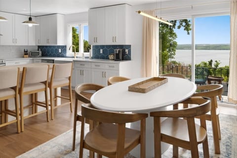 Unit 6466 (1 of 3) Dining area with panoramic lake views, ideal for family meals or entertaining guests. The sleek design and natural light create an inviting atmosphere. 