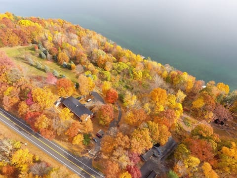 Arial view of the townhomes surrounded by beautiful trees and Cayuga lake.   Experience the vibrant colors from above and the tranquil waters below. 