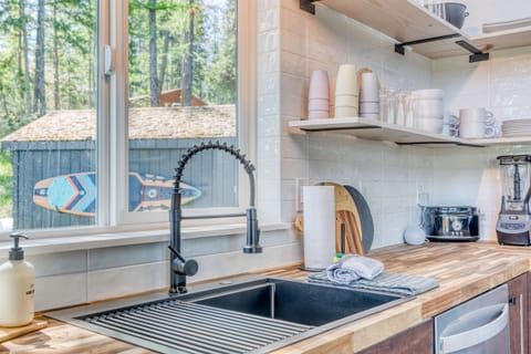 Industrial sink overlooks firepit and boards to remind you to get outside and enjoy your time here!