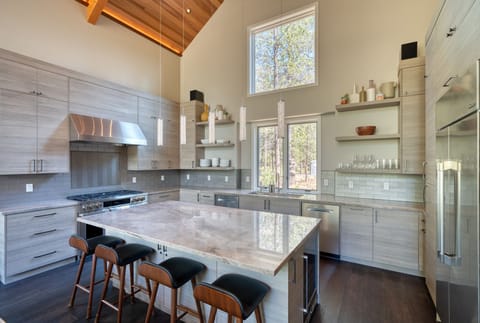 Gather around the marble island, a space designed for cooking and conversation.