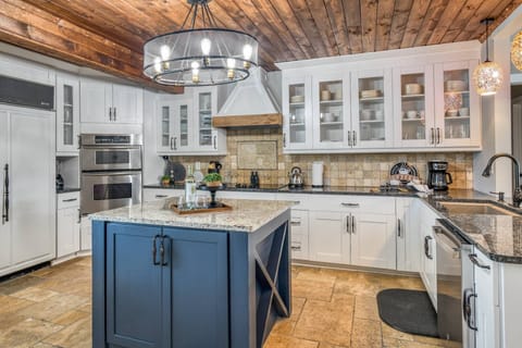 This kitchen is designed with high-level craftsmanship and boasts a built-in oversized refrigerator.