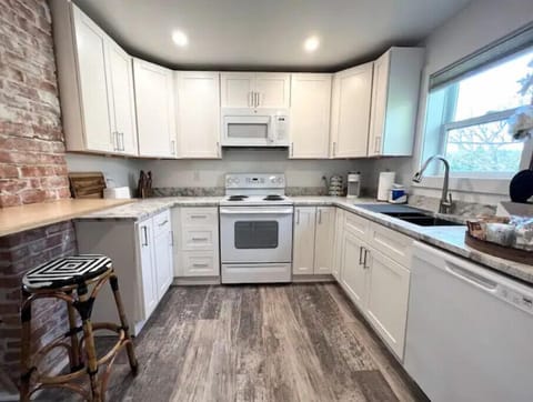 The kitchen features granite counters and is equipped for short & extended stays