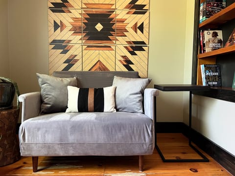 The den has a love seat that extends into a low-profile twin bed.