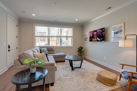 Modern Living Space featuring designer furnishings and a flat-screen SMART TV overlooking the fully equipped kitchen.