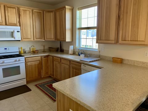 Full kitchen w/fridge, freezer, microwave, stove, oven, coffee pot, dishwasher..