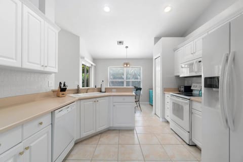 The kitchen resides just behind the living room wall with open access on either end.