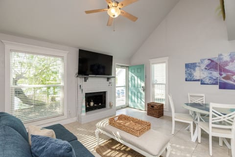 Unwind in your bright, airy living space with vaulted ceilings, cozy fireplace, and charming turquoise door opening to your private retreat.