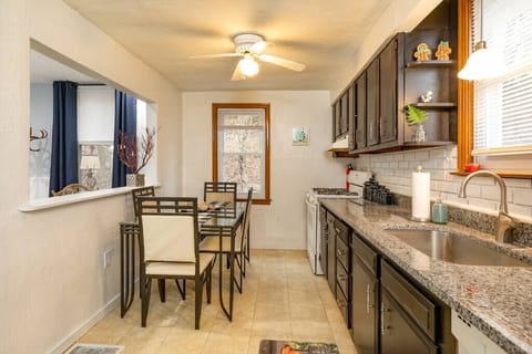 A large galley style kitchen with granite countertops and full table.  Fully stocked with all appliances and cooking supplies