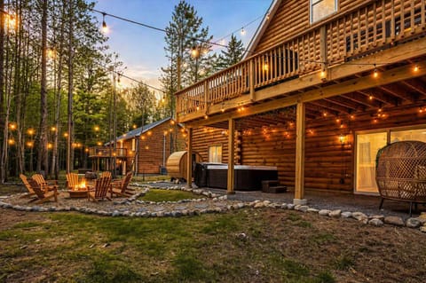 Luxury Cabin Exterior at Sunset with String Lights & Covered Deck
