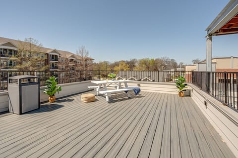 Communal rooftop patio featuring outdoor dining and city views.