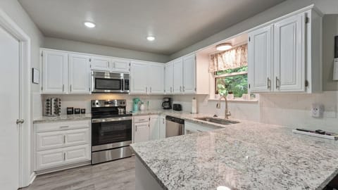Kitchen includes cookware, plates, utensils, pots, pans, bakeware.