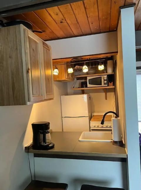 Kitchen with Bar Seating and Drip Coffee Maker