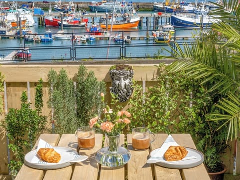 You could throw a pebble into the harbour from this cosy little patio. Hear fishermen on their boats and smell the salty air | Old Quay, Newlyn