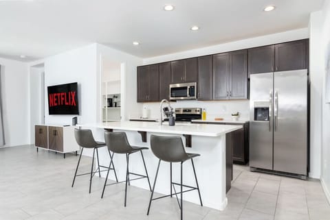 The kitchen has everything: modern cooking appliances and spacious quartz countertops!