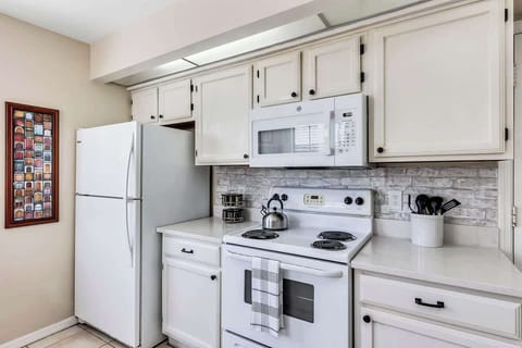 Clean and well functioning kitchen with breakfast nook w/2 chairs, oven, microwave, refrigerator, dishwasher, kettle, spice rack, k-cup & drip coffee maker, blender, toaster, silverware, cups, plates, bowls, coffee mugs, wine glasses, etc.