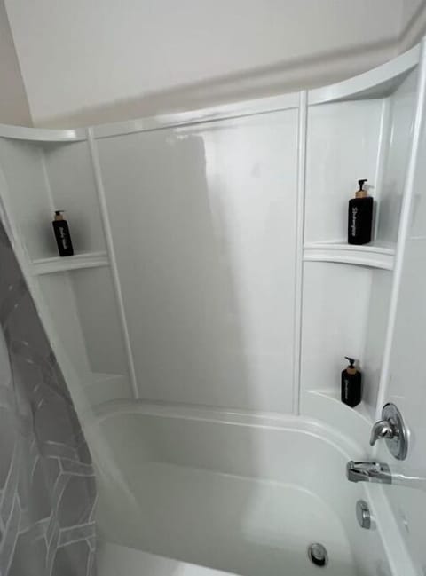 Large bath tub with shampoo, conditioner, body wash 