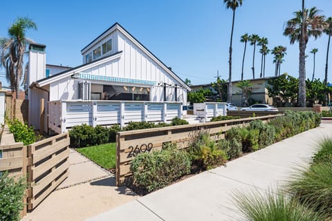 Street view with front yard and front porch with gondala chairs 